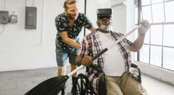 man in wheelchair with AI goggles and a canoe paddle