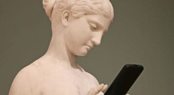 antique statue using a mobile phone